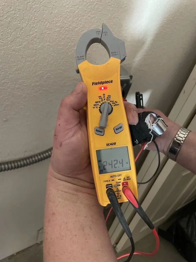 Voltage testing with clamp meter during Outlet Installation in Salford